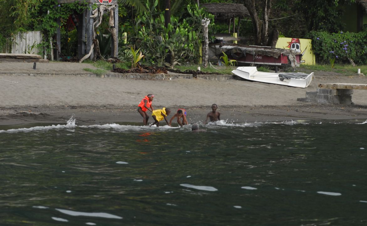 Small children playing in the water at Wallilabu Bay on the island of Saint-Vincent Small children playing in the water at Wallilabu Bay on the island of Saint-Vincent